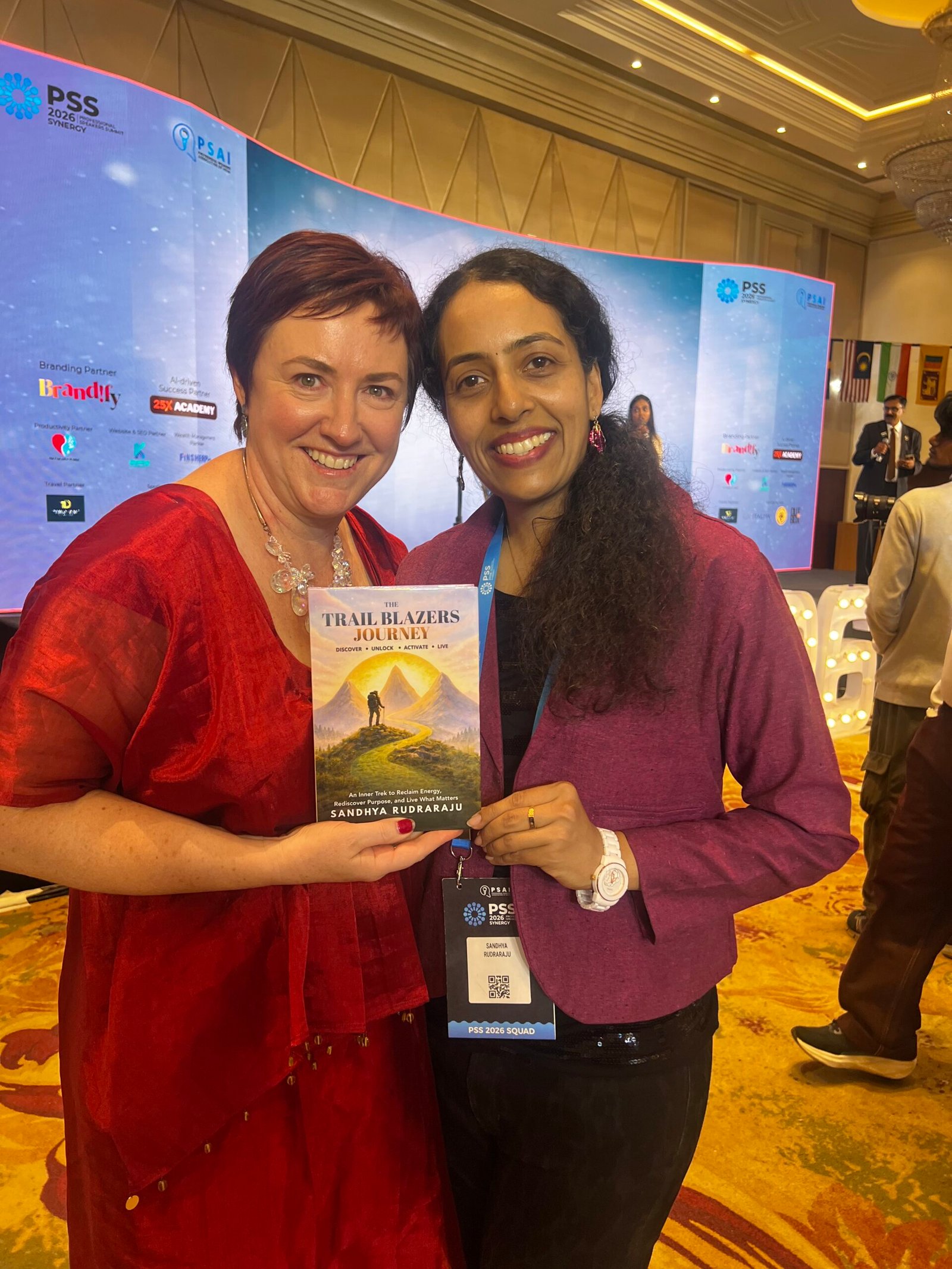 Sandhya Rudraraju with a global leader holding The Trail Blazers Journey
