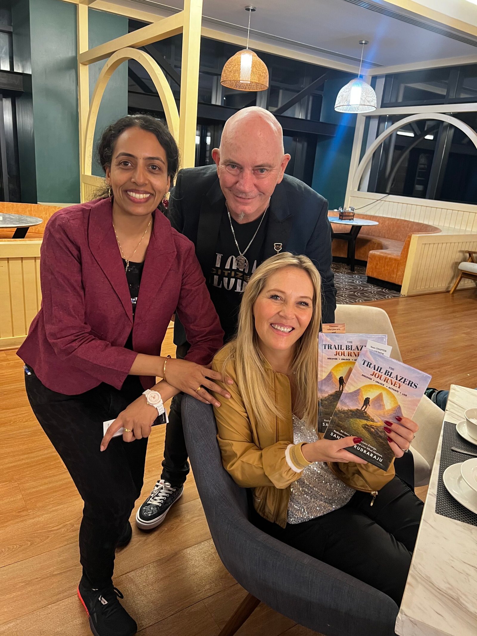 Sandhya Rudraraju with a global leader holding The Trail Blazers Journey