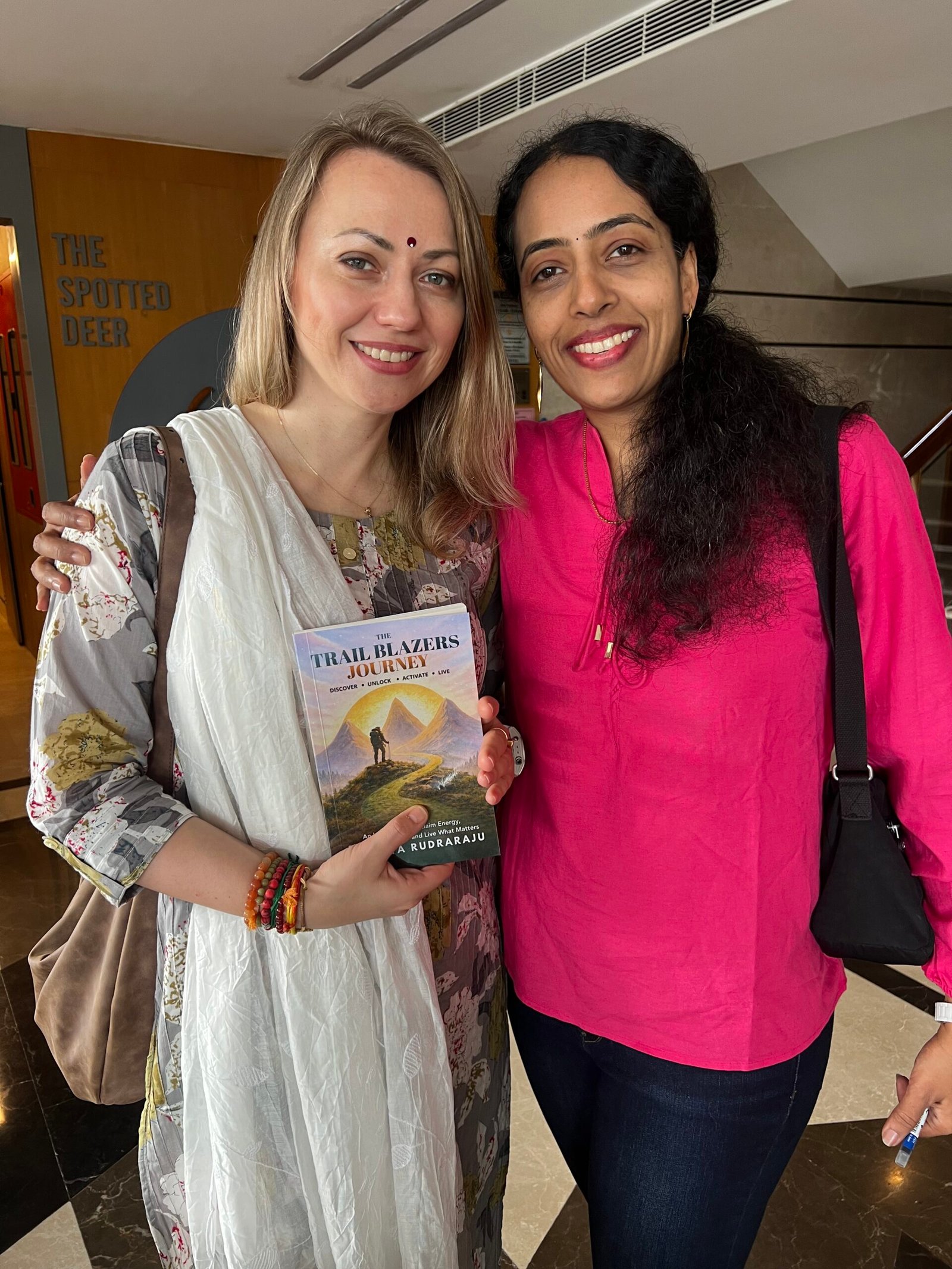 Sandhya Rudraraju with a global leader holding The Trail Blazers Journey