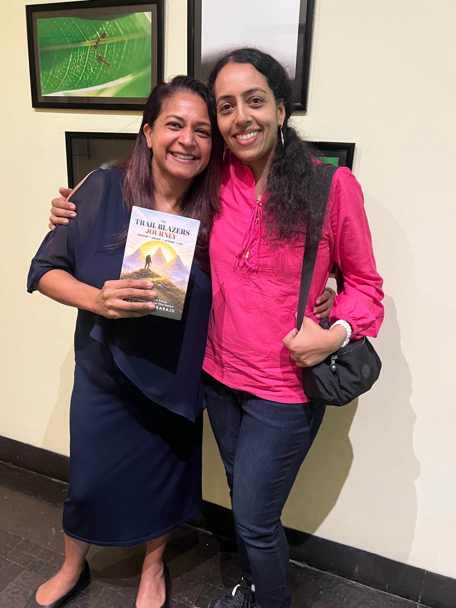 Sandhya Rudraraju with a global leader holding The Trail Blazers Journey