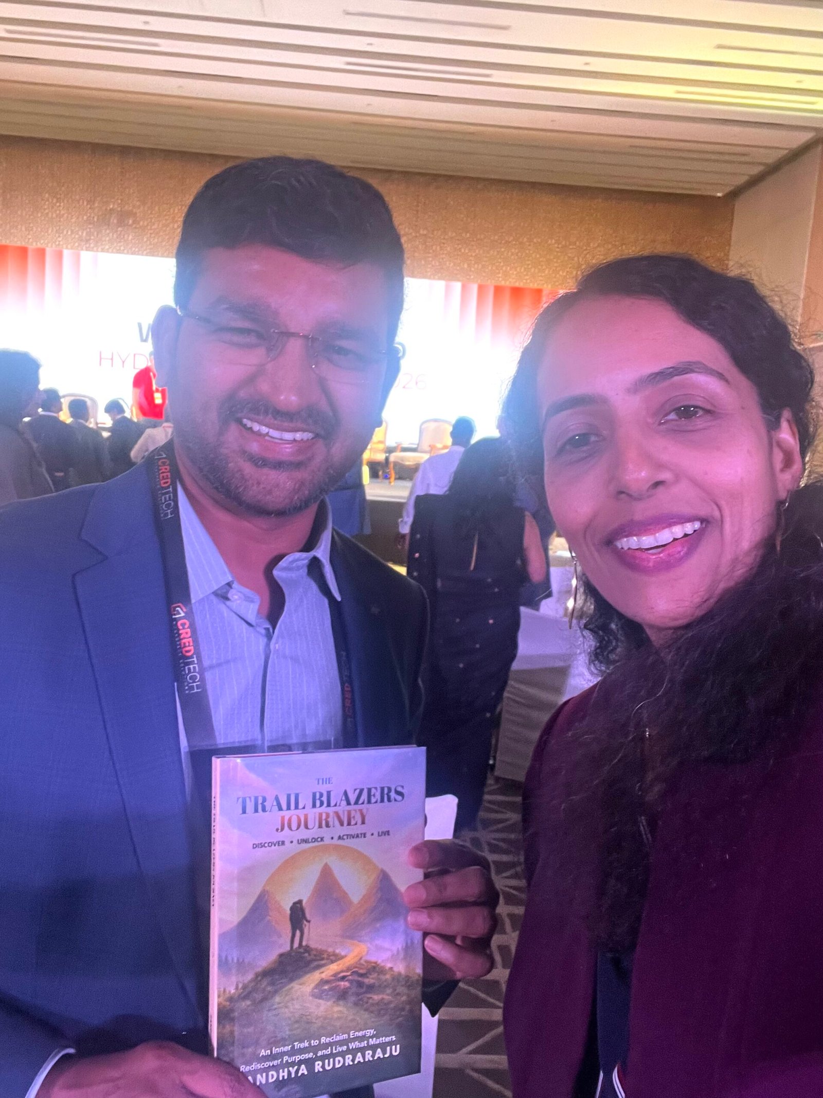 Sandhya Rudraraju with a global leader holding The Trail Blazers Journey