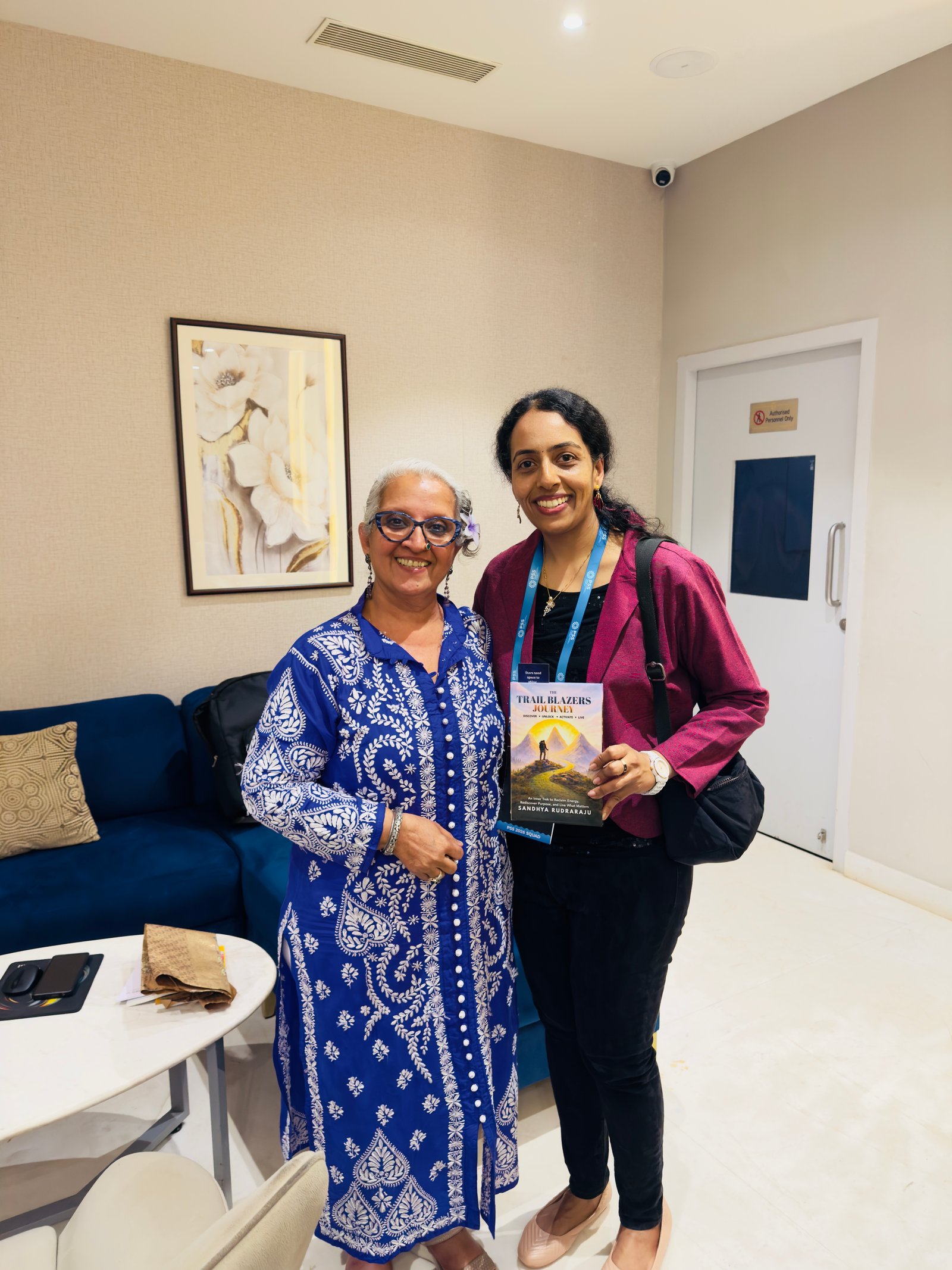 Sandhya Rudraraju with a global leader holding The Trail Blazers Journey